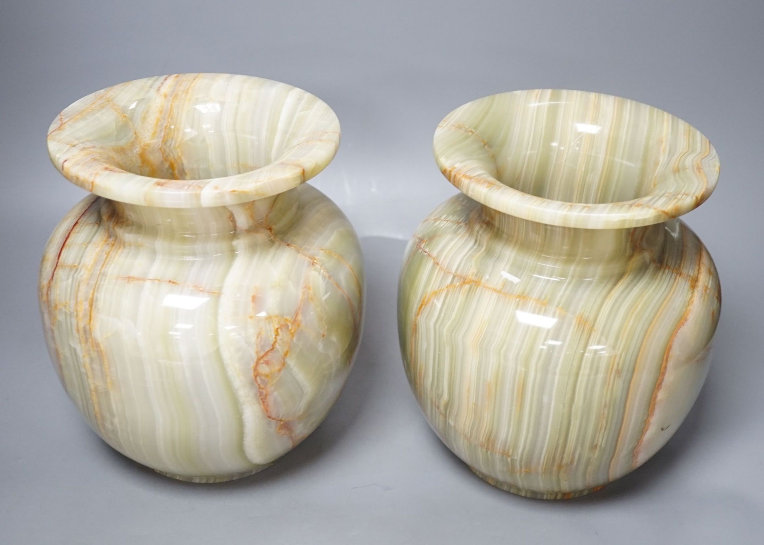 A pair of green onyx vases, 23 cms high.